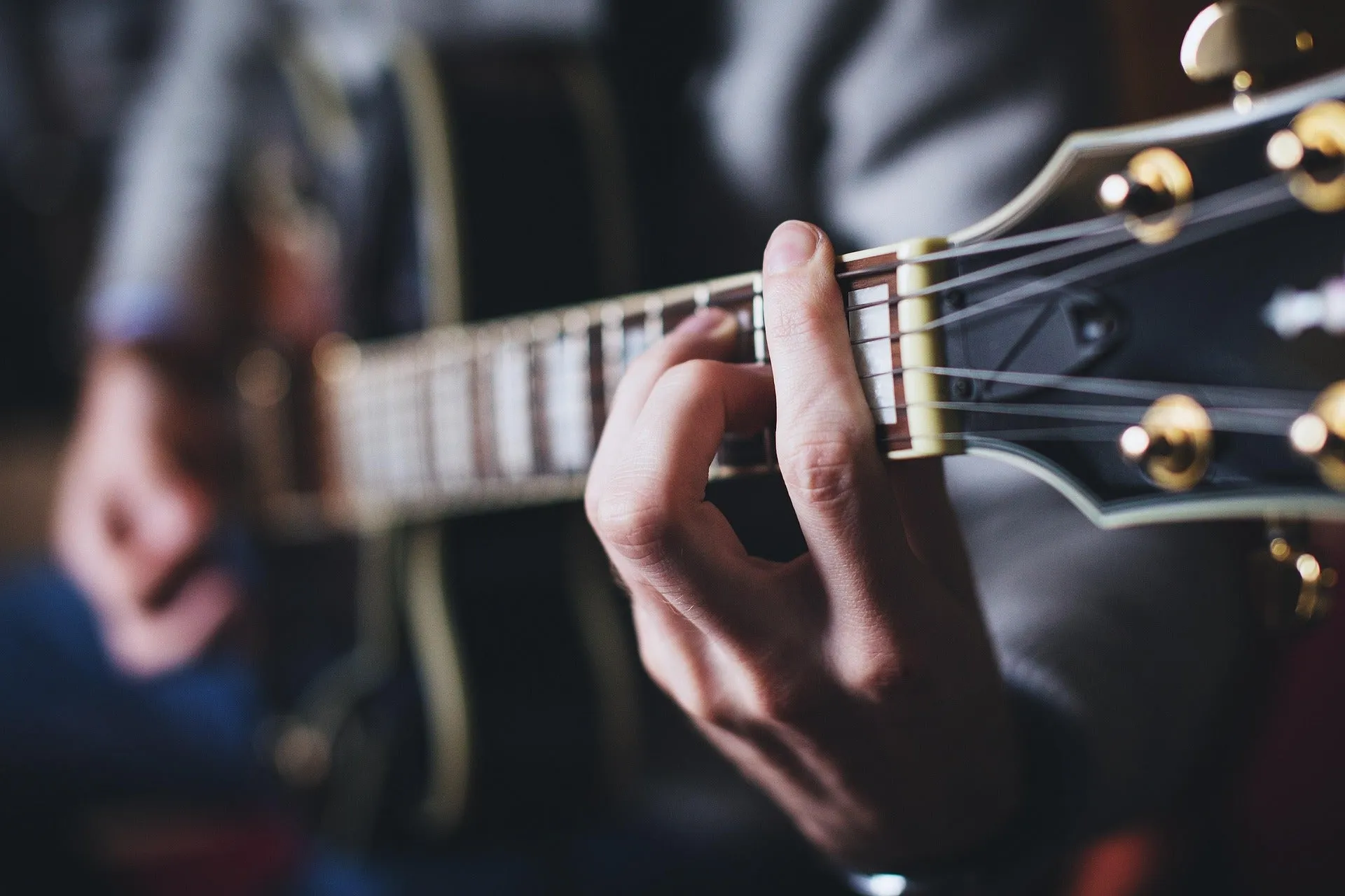 Close-up of a student learning guitar technique